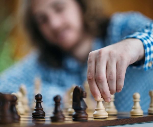 hand-of-chess-player-moving-the-chess-piece-2021-08-27-19-36-56-utc-min.jpg