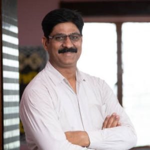 portrait of Indian male Teacher outside of Library